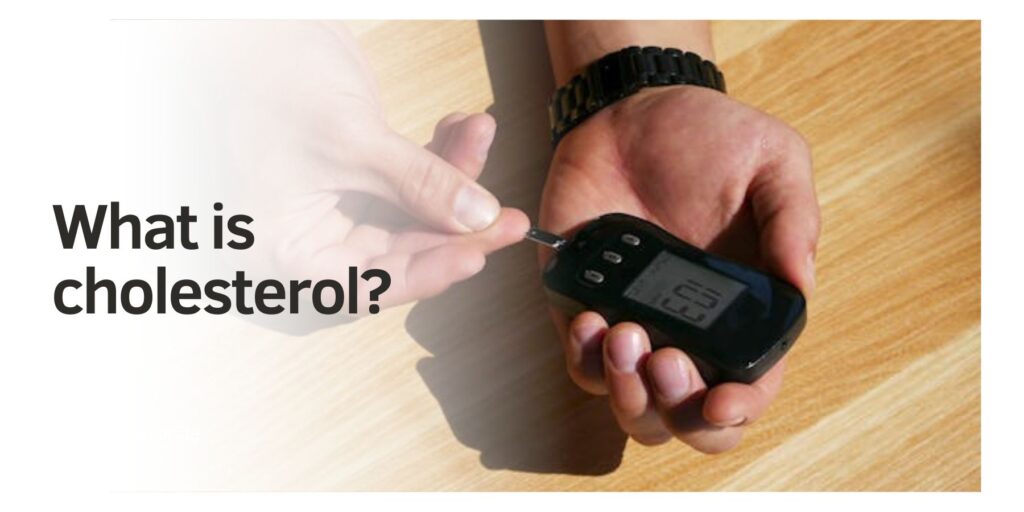 A person using a digital cholesterol monitor, holding it on a wooden table, related to high cholesterol